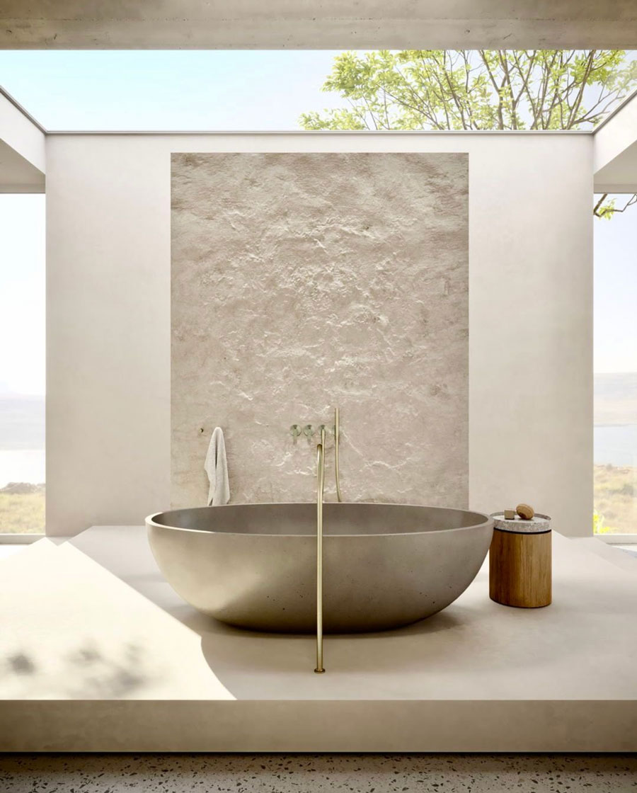 isolated bath tub against stone wall